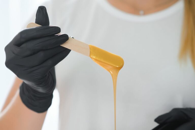 Esthetician preparing warm wax for waxing in Jumeirah at Zuri Beauty Lounge