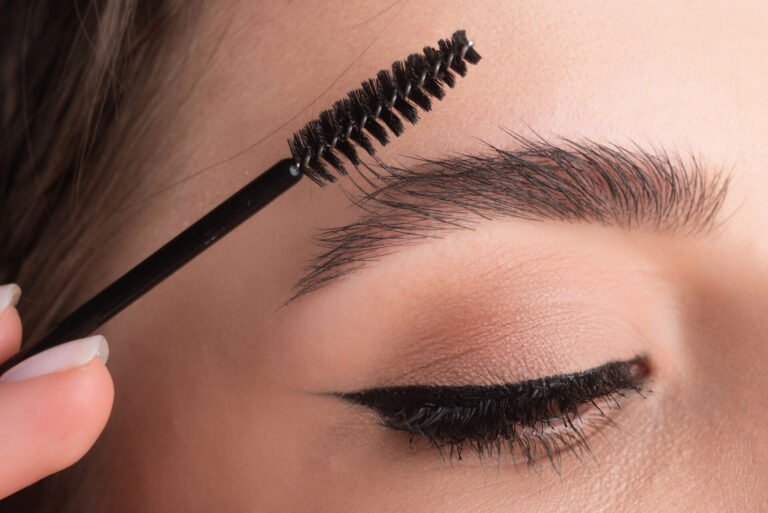 Close-up of eyebrow lamination being brushed into shape